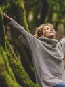 Overjoyed happy woman enjoying the green beautiful nature woods