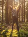 Young man in silent forrest with sunlight